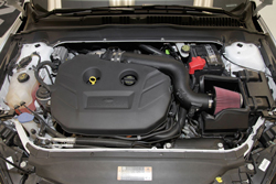 The 2013-2014 Ford Fusion EcoBoost intake air filter is shrouded by an application specific air filter heat shield built to snap onto the factory lower air box housing