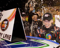 Teammates shower 17-year old Ben Rhodes as they celebrate his third NASCAR K&N Pro Series East win at Bowman Gray Stadium in North Carolina