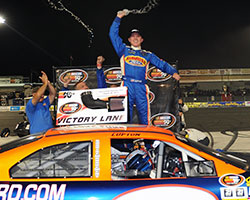 Dylan Lupton celebrates the victory on top of his race car