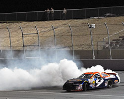Dylan Lupton celebrates his second NASCAR K&N Pro Series West Race victory by doing a burnout in the number 9 Sunrise Ford of Fontana Fusion on the Kern County Raceway Park infield
