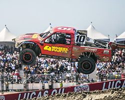 The #10 Team 4 Wheel Parts truck launched side by side through the air and made contact with another truck resulting in a brake issue for Greg Adler