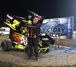 Jake Andreotti proudly poses with his trophy and the number 7P K&N Filters Micro Sprint Car in victory circle at Plaza Park Raceway in Visalia, California