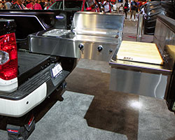 A Solaire 27 grill slides out on a custom system from the 1794 Edition Tundra’s bed