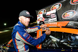 Ryan Partridge adding sticker after winning NASCAR K&N Pro Series West race at Tucson Speedway in Arizona