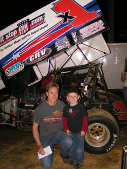 Andy Forsberg in front of the F&F X1 360 Sprint Car and a Fan