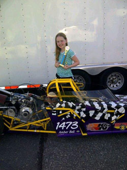Amber proudly displays her first round trophy from the team's last race at Maple Grove Raceway.