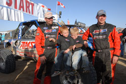 At the finish line of the King of Hammers race it’s Lovell, his twin three-year-old boys Adam and Byam, and Bill Kunz (left to right)