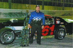 Brad Sprionger poses with his trophy after recently winning the 2011 points race at the Angola Speedway.