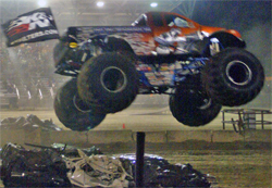 Iron Warrior flies the K&N flag as Trey Myers flies over car stacks in the wheelie contest