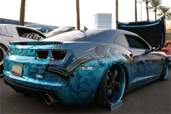 This Camaro SS combines tribal designs with ghost like images on a bright blue background at SEMA