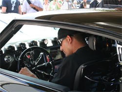 Custom steering wheel by Dave Fishman Rivera compliments the all black interior and trunk with eather and ostrich skin

