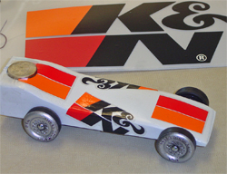 Pinewood Derby vehicle decorated withK&N stickers