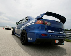 Modifications on Gates' 2008 Mitsubishi Lancer Evo X include an AMS carbon Kevlar roof and JDM RS grilles, photo by Rich Karbowiak from AMS