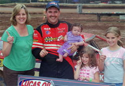 Peggy and Ray Cook with daughters celebrate in the Winner's Circle at Tyler County Speedway in Middlebourne, West Virginia, photo by Todd Turner