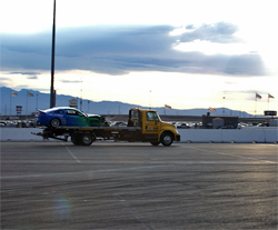 Gittin though he could drive to the pits after he hit the wall, then realized his 2010 Ford Mustang was on two wheels, photo by John Choi, provided by Falken Tires