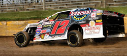 Jason Gross holds the checkered flag at Rice Lake Speedway in the Dirt Modified class
