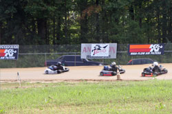 Racers screaming around a sweeping left-hand turn.
