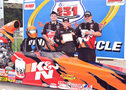 (Left to Right) Crewman Shane Colley, Driver Kathy Fisher, Husband and Teammate Kevin Fisher and 1 yr old Mekoh, celebrate the IHRA Quick Rod final for the K&N Engineering ride in Martin, MI