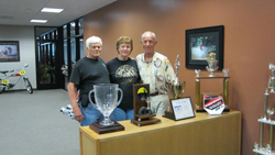 Norm McDonald, his wife Lucy, and Malcom Smith recently posed for a picture at Malcolm Smith Motorsports