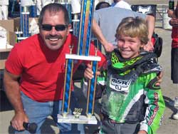 Marshall Stewart with winning trophy and track announcer Mike Yellich