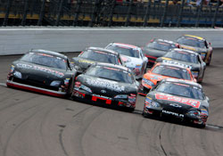 Drivers raced three-wide as they crossed the start-finish line for the final lap of the race.