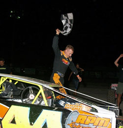 After a recent feature race at the Blackock Speedway, Russell Morseman crawls out of his car as the victor.