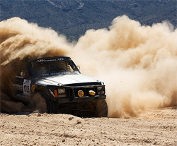 Torchmate Desert Truck surrounded by a plume of dust on the 250 mile off road course in Nevada, photo by Chad Jock Photography