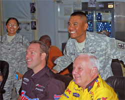 NHRA Pro Stock Champions Warren Johnson and Jason Line pose with American soldiers in Kuwait