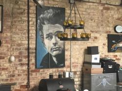Exposed brick wall with James Dean artwork