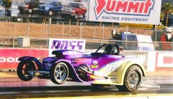 Shot of Kevin McClelland pulling the front wheels up on the drag strip.