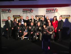 View of the NMCA WEST recipients of the Nitto Tire Diamond Tree Championship rings on stage.