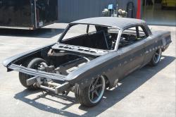 The stripped Oldsmobile body shell test-fitted to the new chassis from Roadster Shop