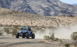 Photo of Pellegrino and Lasher as they head wide open through the desert prepping for the next trail