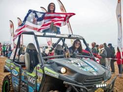 Shot of Sara Price and Erica Sacks flying the US flag over their side by side in Morocco.