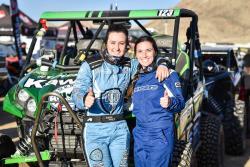 Shot of Sara Price and Erica Sacks in front of the Kawasaki Teryx side by side