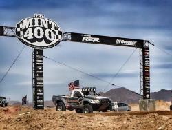 Photo of the Total Chaos truck staged and launching off the start line at the Mint 400