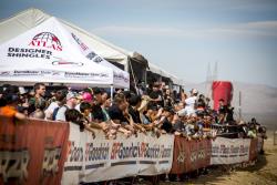 Photo of spectators lined up to watch the unlimited truck class as they fly by!