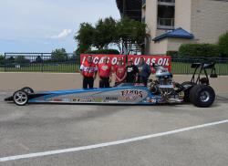 The Martino family including Tom, Neil, Jimmy and Ryan stand with their dragster.