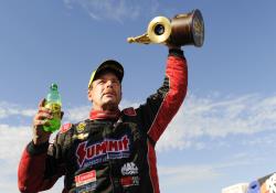 Greg Anderson holds up his Wally after taking the win at the NHRA Midwest Nationals