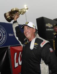 Bo Butner holding the Championship Trophy after winning the 2017 NHRA Auto Club finals at Pomona